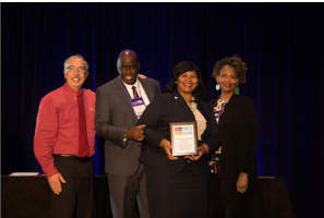 Photo of Ray Belton accepting award.