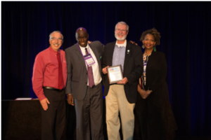 Photo of Mike Abbiatti accepting award.