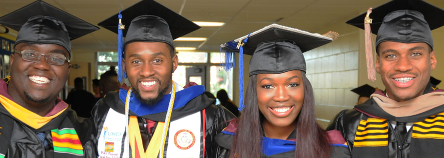 image of four students wearing graduation caps.