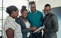 Image of 4 educators using  a tablet device